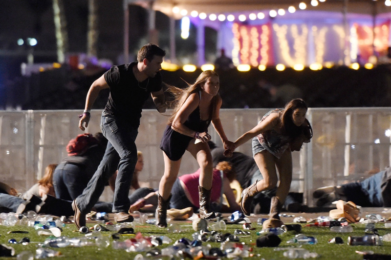 People run from the Route 91 Harvest country music festival after apparent gun fire was hear on October 1, 2017 in Las Vegas, Nevada.(Photo by David Becker/Getty Images)